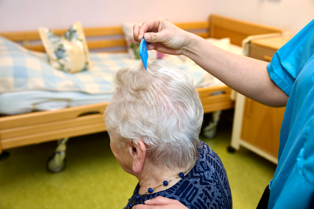 Pflegekraft kaemmt einer Bewohnerin die Haare © Werner Krueper/epd-bild / picture alliance